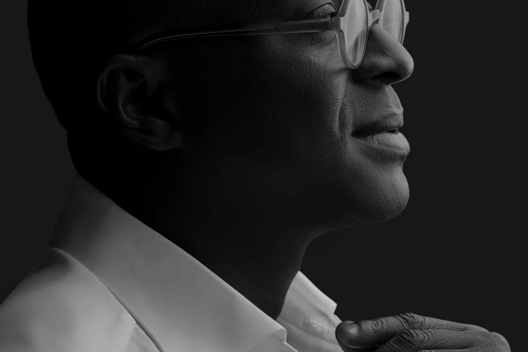 Black-and-white profile of a man in glasses looking upward
