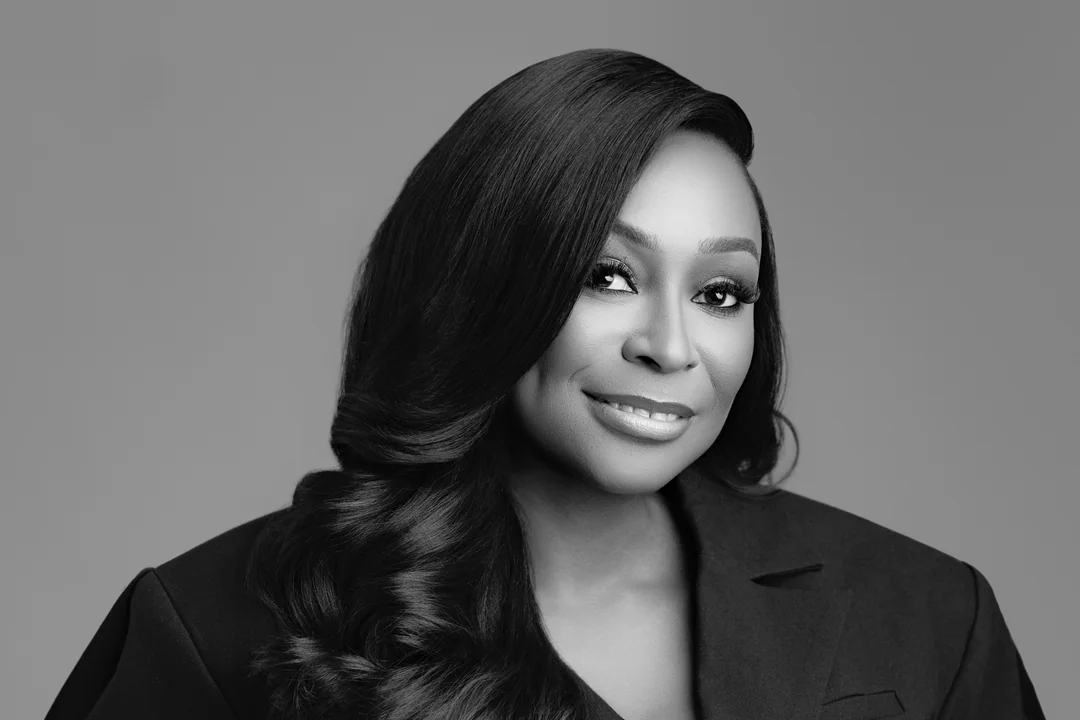 Black-and-white portrait of a woman in a dark tailored suit